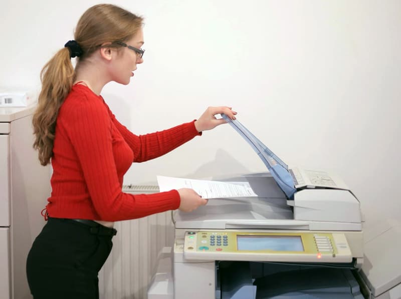 Lady using old photocopier